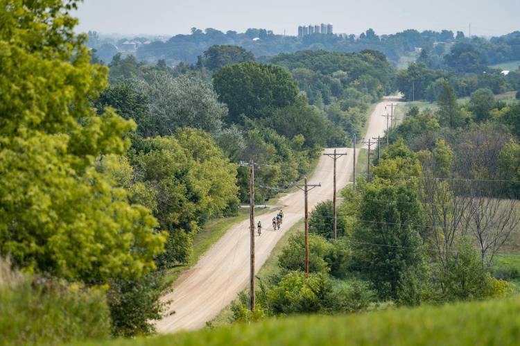 Cyclists racing across a fire road in the Day Across Minnesota bike race